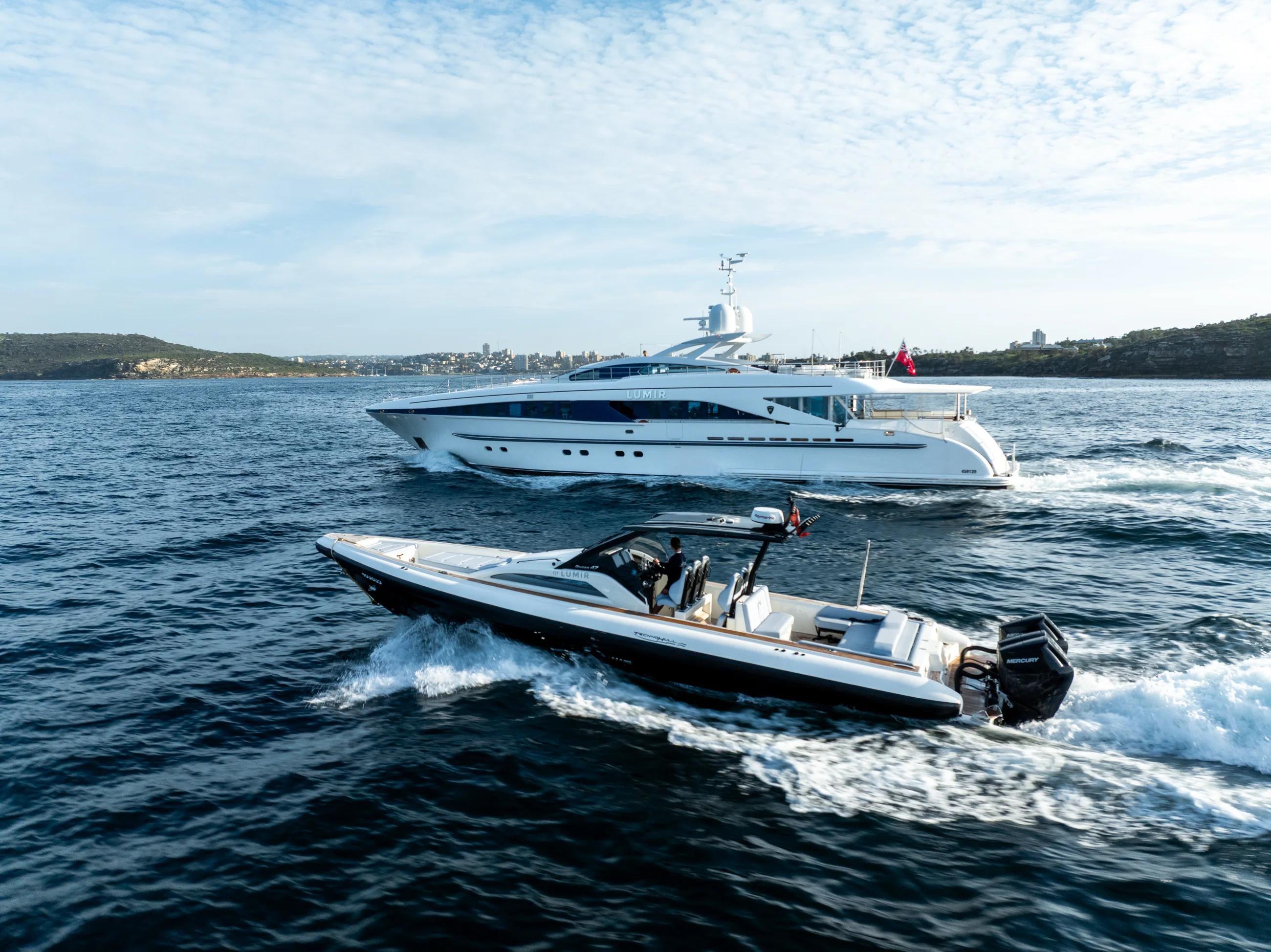 A fast tender running wide across open water off the Queensland coast
